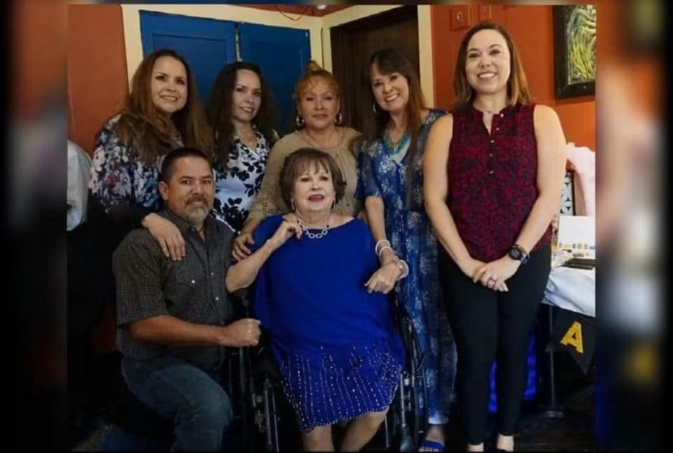 Louis surrounded by family at a gathering